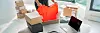 Online store selling clothes on website working on laptop ecommerce business from home. Woman packing new clothing fashion purchase in shipping packages for delivery. Panoramic banner.