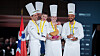 Det norske laget som vant sølv i Bocuse d'Or Europe 2026. Til høyre kandidat Christian A. Pettersen, som har commis Hanna Korvald ved sin side. Til venstre Filip August Bendi. Bak skimtes Ørjan Johannessen.